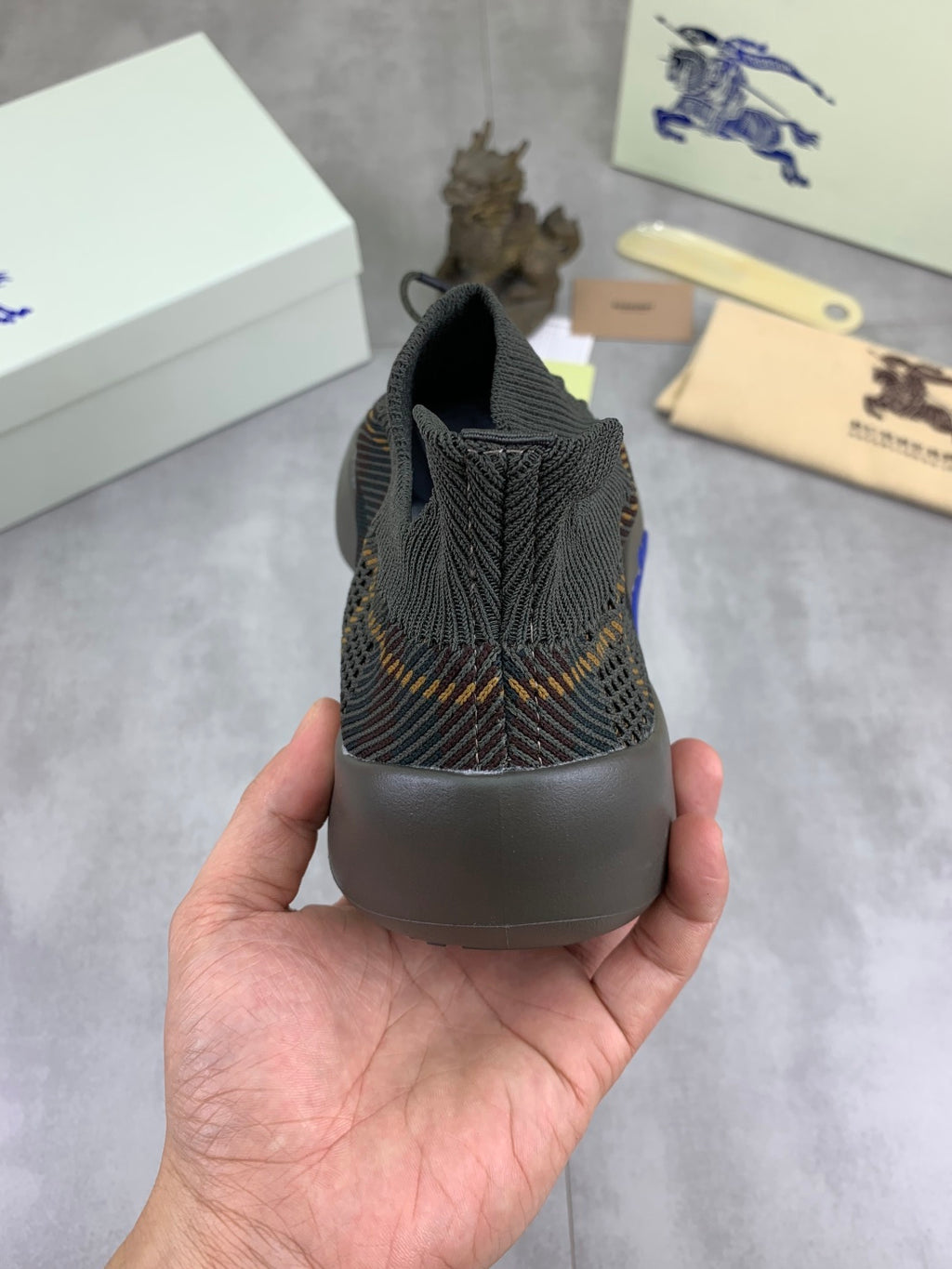 Burberry knit sneaker heel view with dark plaid upper and cushioned collar