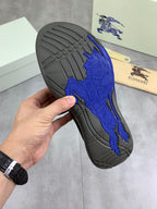 Burberry sneaker outsole with textured tread and blue horse emblem detail