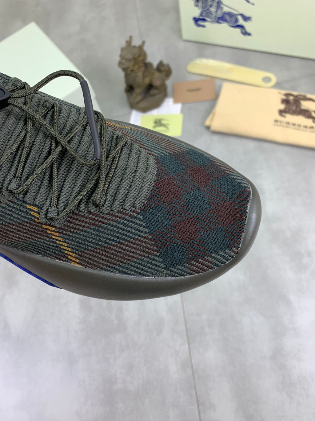 Burberry knit sneaker toe and laces in dark plaid with blue trim along side