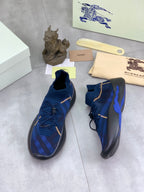 Burberry blue knit sneakers with gold trim and blue plaid texture, rear and side view