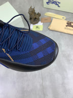 Burberry blue knit sneaker upper detail with gold trim stitching and plaid pattern