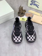Pair of black and white check knit sneakers with lace-up details and blue soles