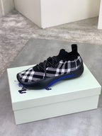 Black and white check knit sneaker on box, rounded toe and blue sole