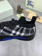 Black and white check knit sneaker with sock collar and blue sole detail, side view