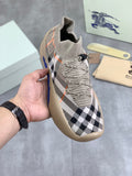 Knit slip-on sneaker with black-and-white check pattern and blue outsole trim