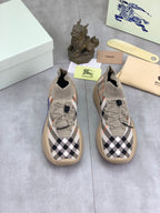 Pair of knit slip-on sneakers in black-and-white check pattern with beige soles