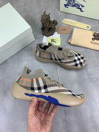 Knit pull-on sneaker with black-and-white check pattern and blue sole stripe