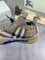 Knit pull-on sneaker with black-and-white check pattern and blue midsole