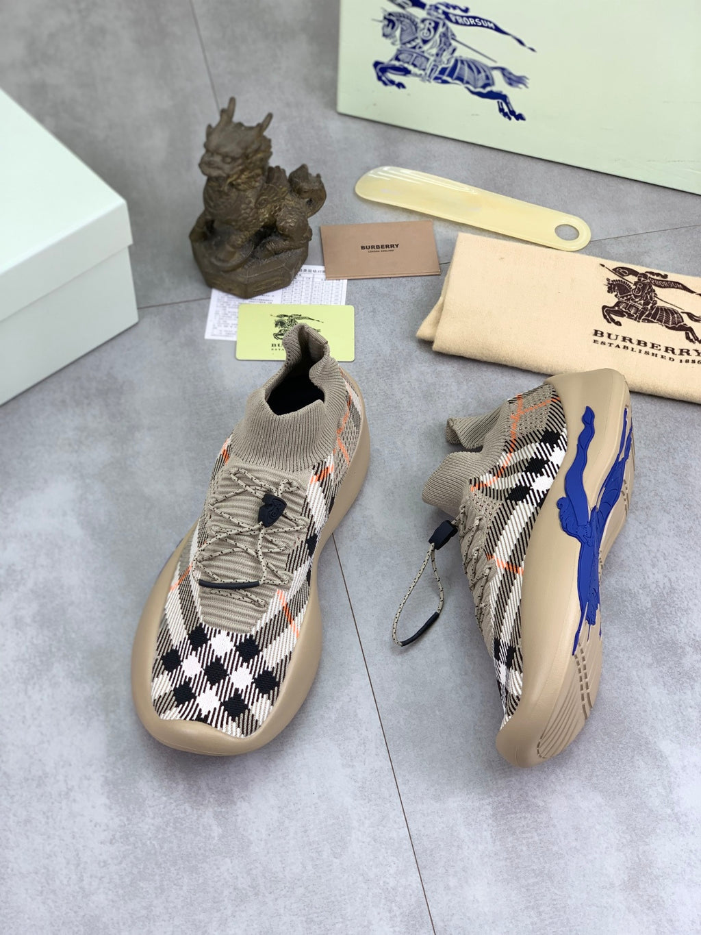 Knitted slip-on sneaker with black-and-white check upper and blue accent sole
