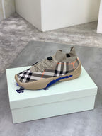 Knit slip-on sneaker on box: black-and-white check upper with blue side stripe
