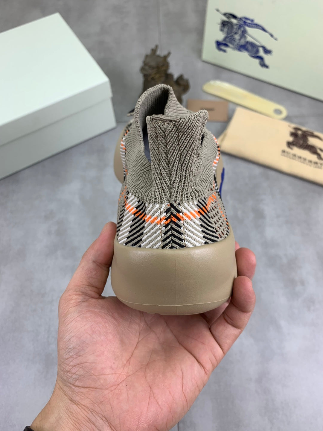 Back view of knit pull-on sneaker with black-and-white checks and beige heel