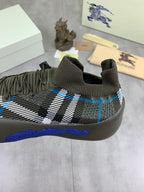 Burberry knit sneakers front view, dark olive with black-and-white check and blue trim