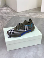 Burberry knit sneakers on white box, dark olive with check pattern and blue sole edge