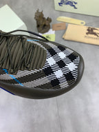 Burberry knit sneaker upper close-up, olive with black-and-white check and blue stitch details