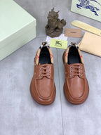 Pair of Burberry brown leather boat shoes with lace-up eyelets and stitched toe seams