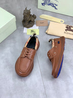 Burberry brown leather boat shoes with lace-up eyelets and a textured rubber sole