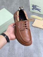 Burberry leather boat shoes in brown with lace eyelets and low profile sole