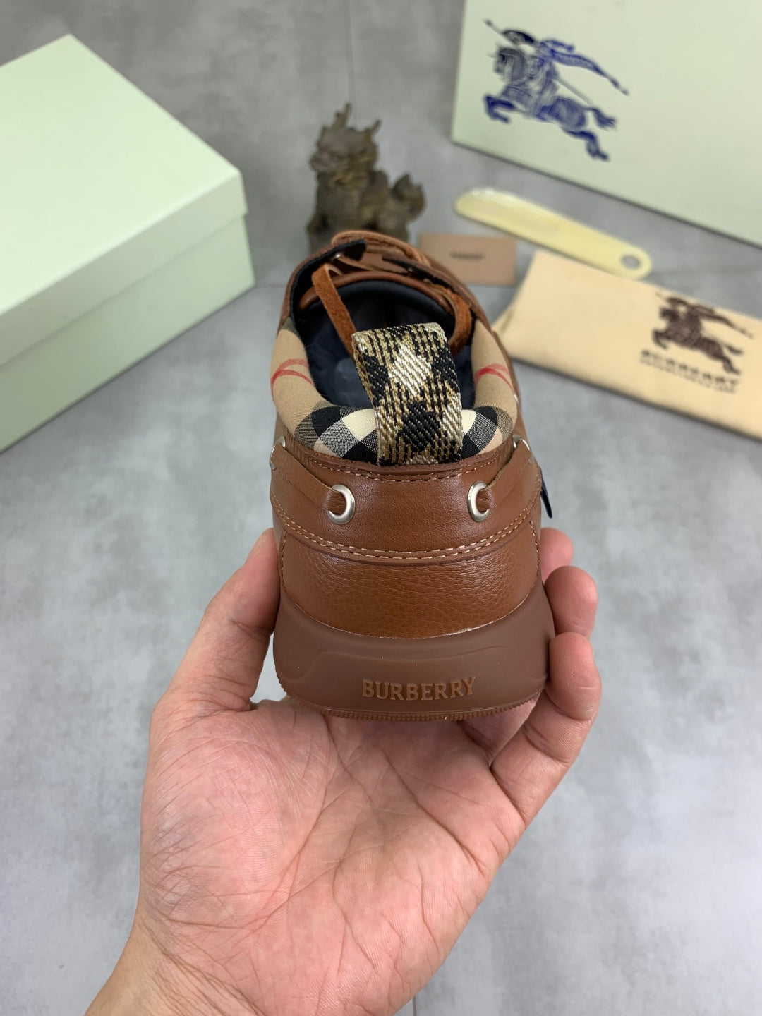 Burberry brown boat shoe with heel tab and check-pattern interior underlay