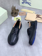 Burberry leather lace-up shoes in dark blue, side view with stitched detailing