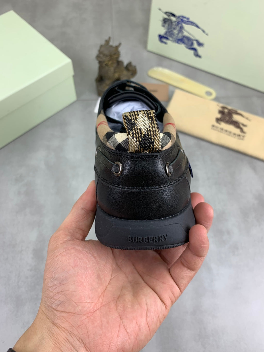 Burberry leather lace-up shoe with dark upper and Burberry logo on the heel counter