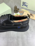 Burberry leather lace-up shoe with dark upper and plaid check lining at the collar