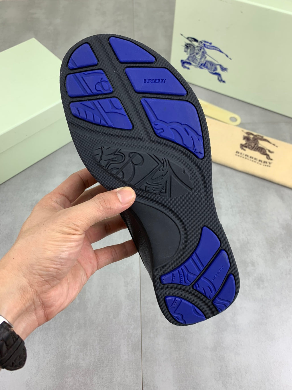 Burberry rubber outsole with blue tread pattern and traction grooves underside