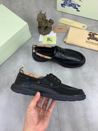Burberry leather lace-up shoes in dark blue shown together with check lining at collar