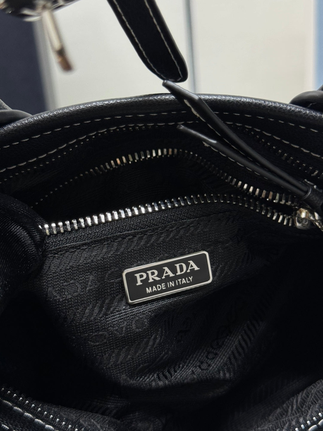 Prada leather-lined interior with zipper and “Prada Made in Italy” label