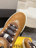 Fendi unisex sneaker close-up: tan suede upper, textured laces, logo patch on side
