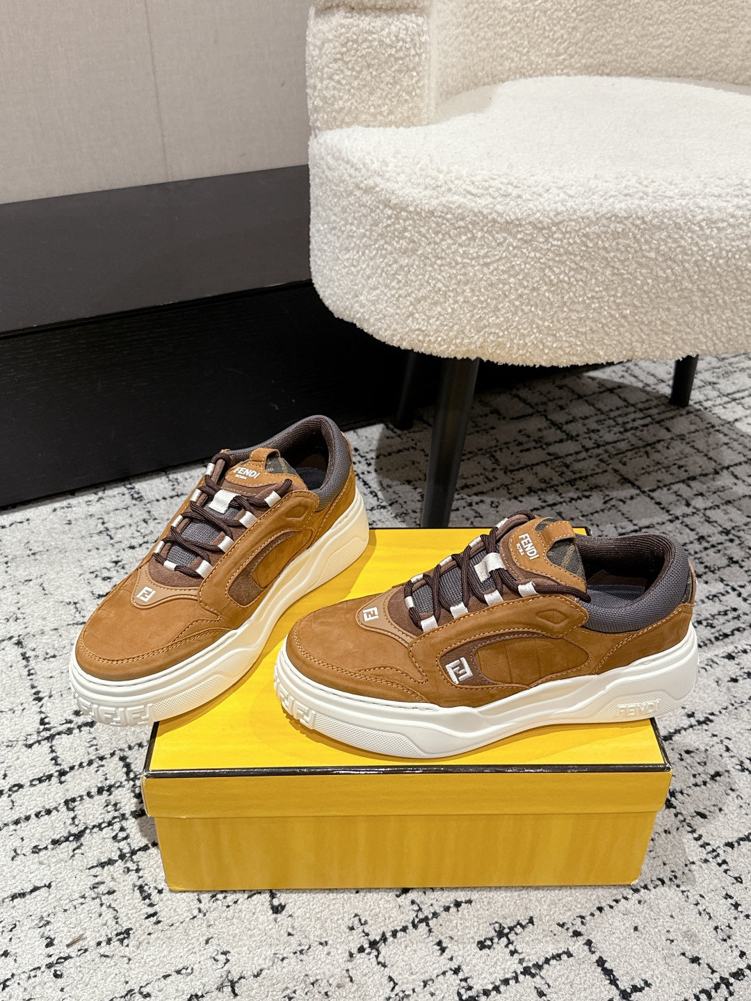 Fendi unisex sneakers on box display: tan uppers, gray accents, white platform sole