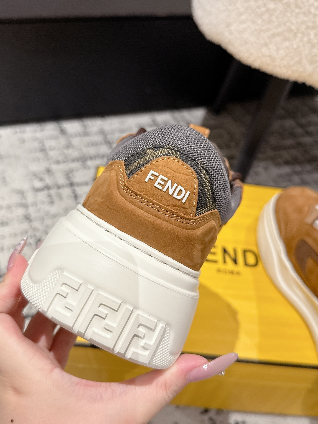 Fendi unisex heel and sole close-up with FENDI logo on gray fabric and white tread
