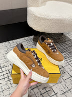Fendi unisex lace-up sneakers in tan with gray socks and white cushioned sole