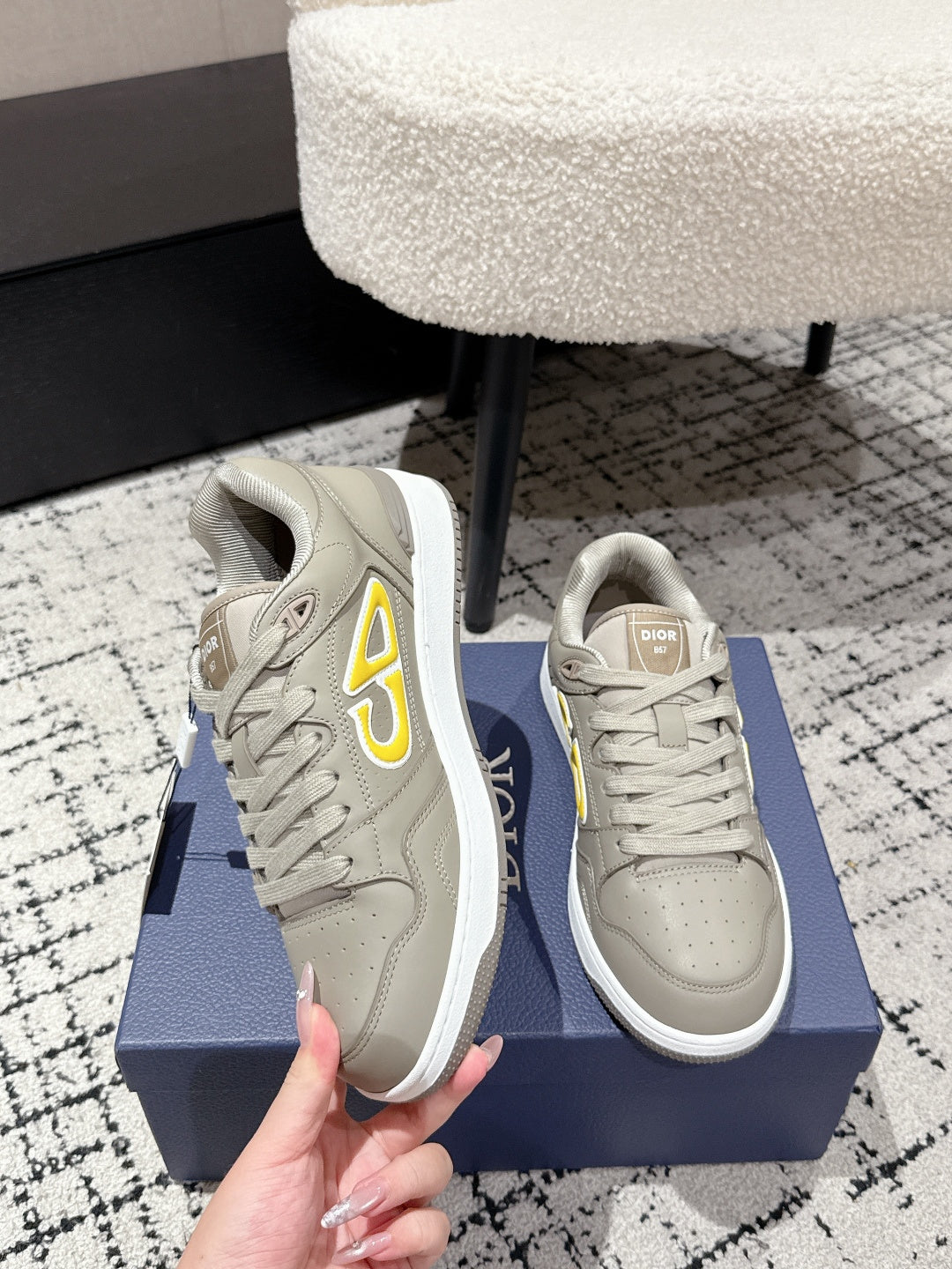 Beige Dior sneakers with side yellow logo detail, lace-up and toe view
