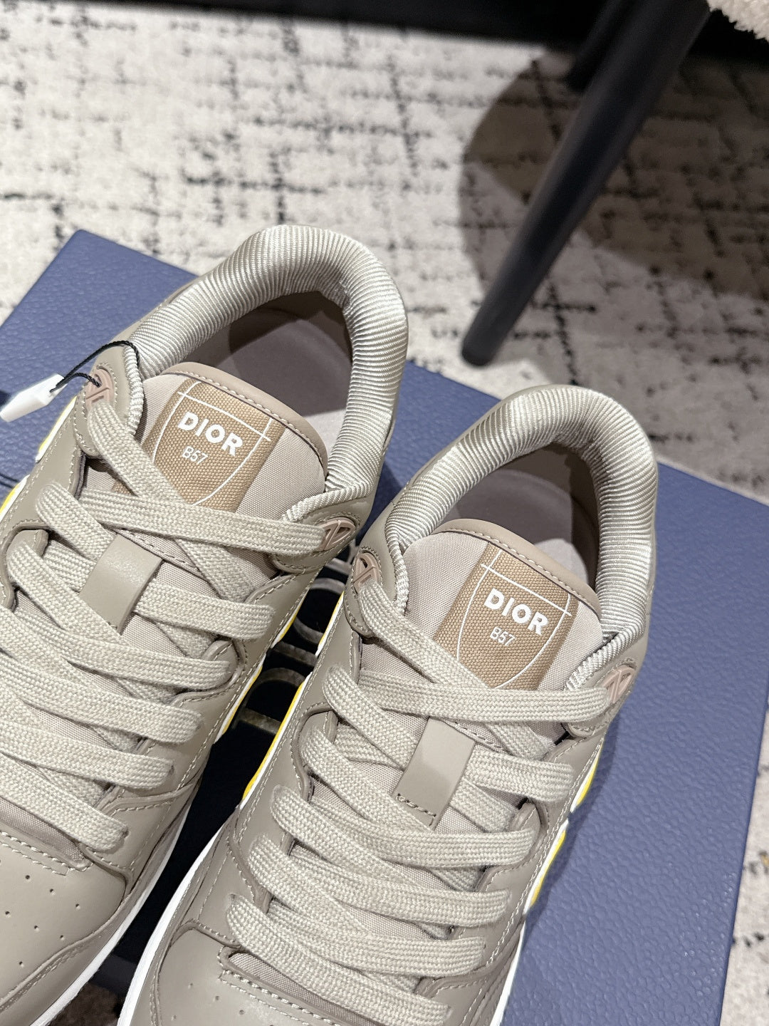 Beige Dior sneakers interior view with woven tongue label and laces
