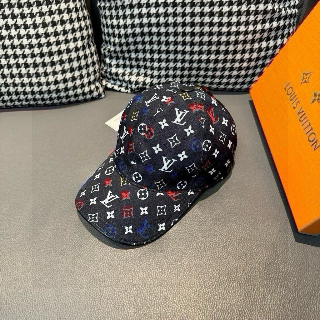 Louis Vuitton cap, black monogram pattern with multicolor symbols, side angle view.
