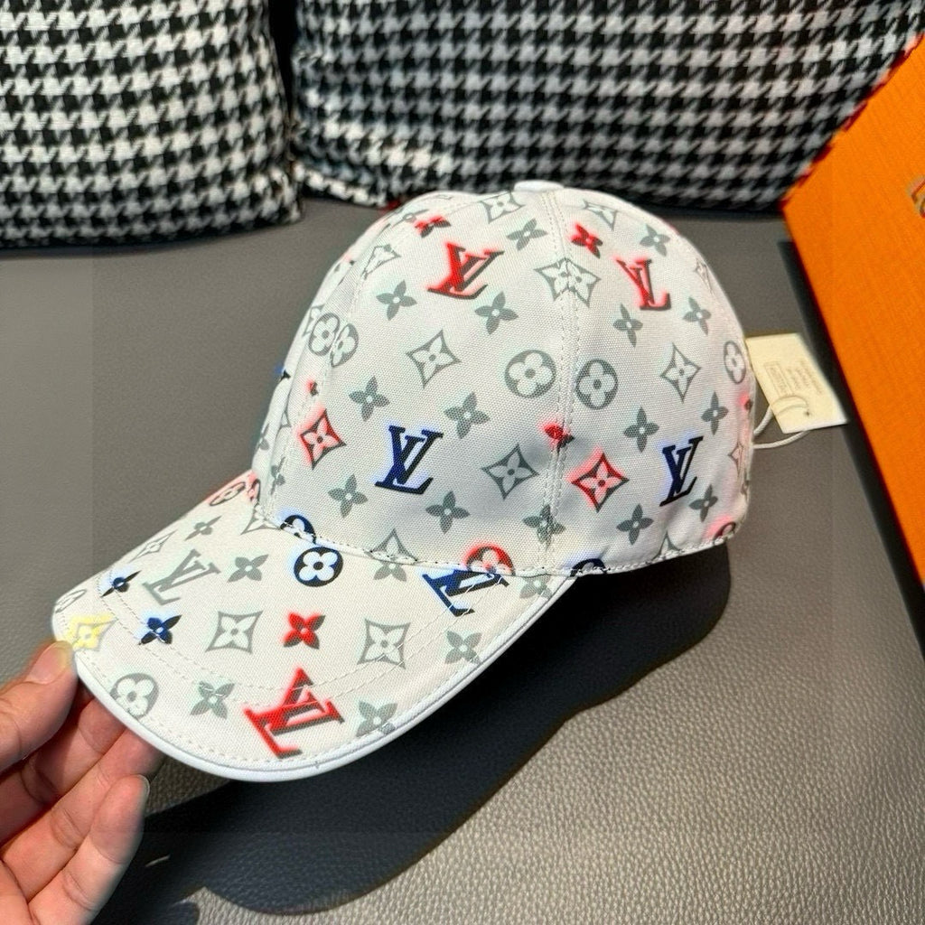 White baseball cap with multicolor monogram print and curved brim, side view.