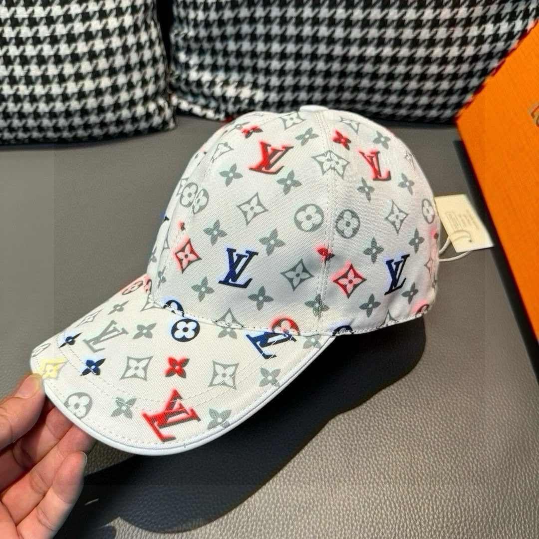 White baseball cap with multicolor monogram print and curved brim, side view.