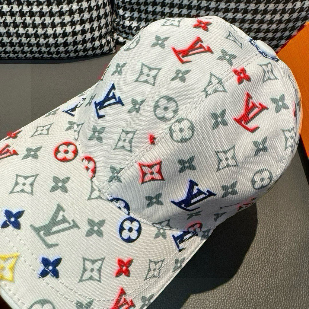 White cap with close-up multicolor monogram pattern and curved brim seam.
