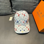 White baseball cap with multicolor monogram pattern and curved brim.