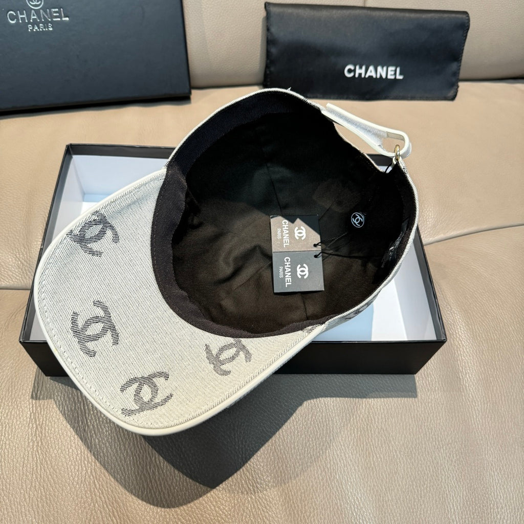 Light gray Chanel logo cap with black interior lining and hanging tags