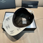 Light gray Chanel logo cap with black interior lining and hanging tags