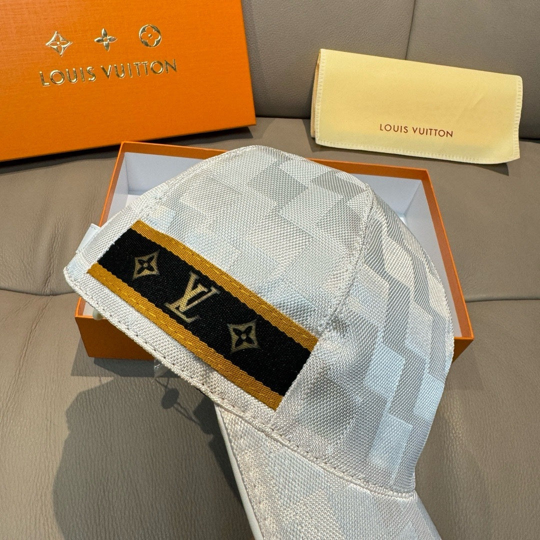 Louis Vuitton cap front panel: black monogram band with gold trim on gray-blue check