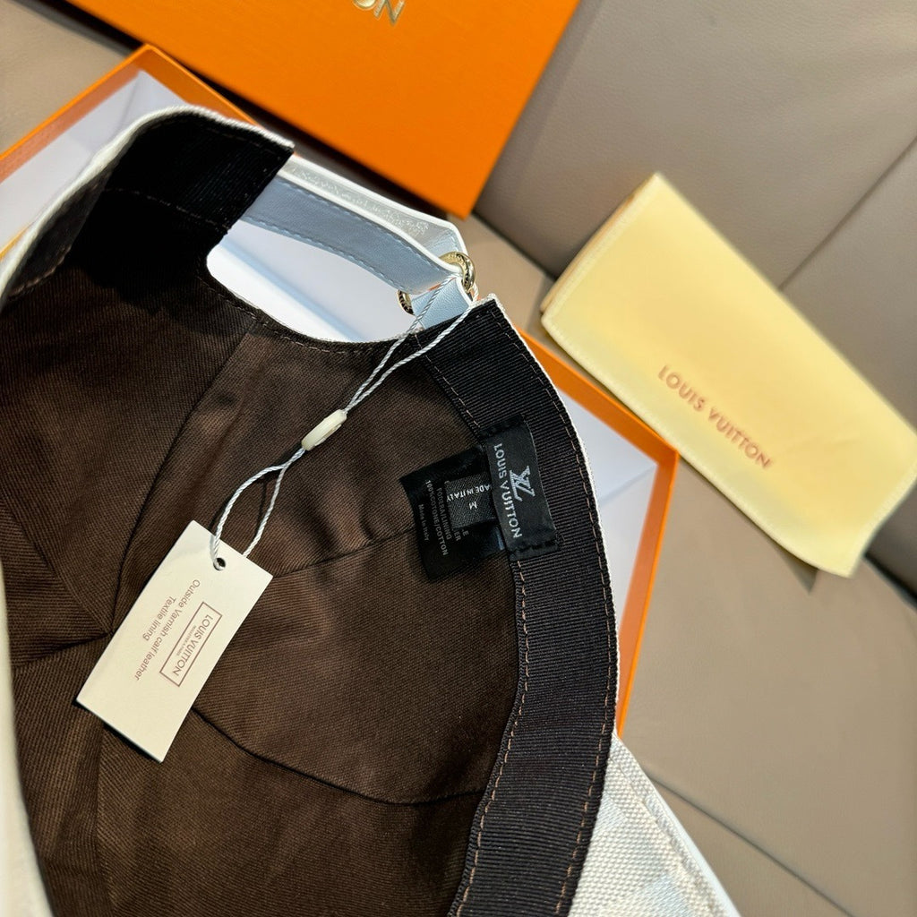 Louis Vuitton cap interior with black lining and hanging tag on light gray-blue hat