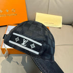 Louis Vuitton black baseball cap with white logo band and angled side view