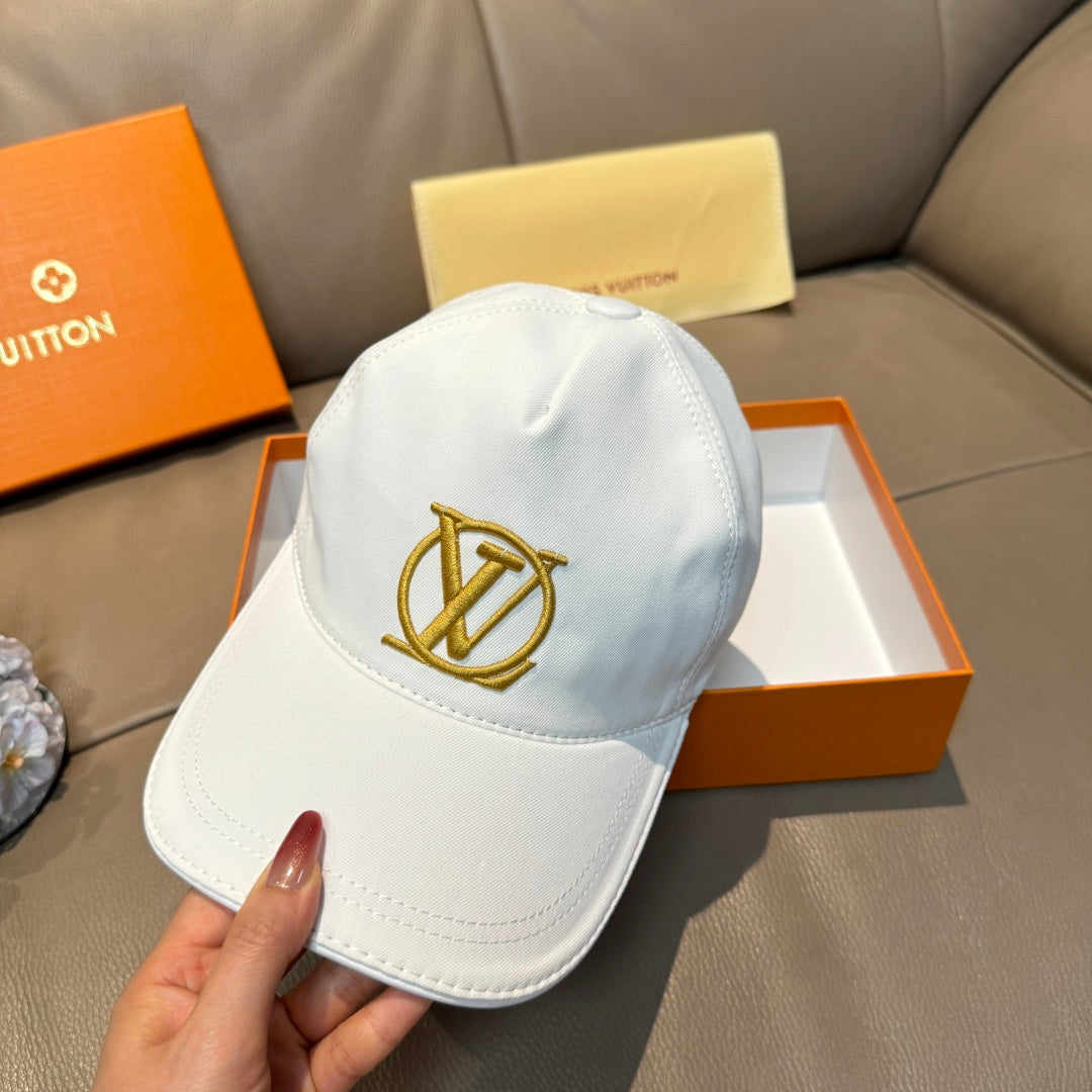 White baseball cap with gold LV monogram emblem centered on the front