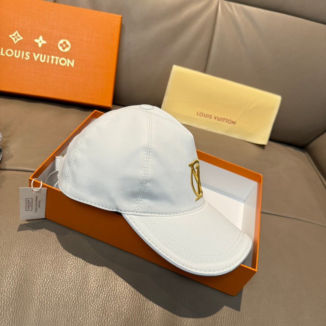 White baseball cap with gold LV monogram logo, curved brim and stitched crown