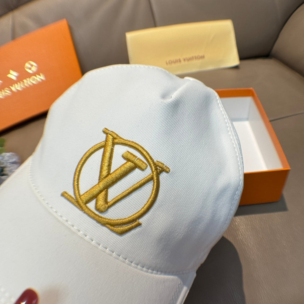 White baseball cap with oversized gold monogram logo on the front panel