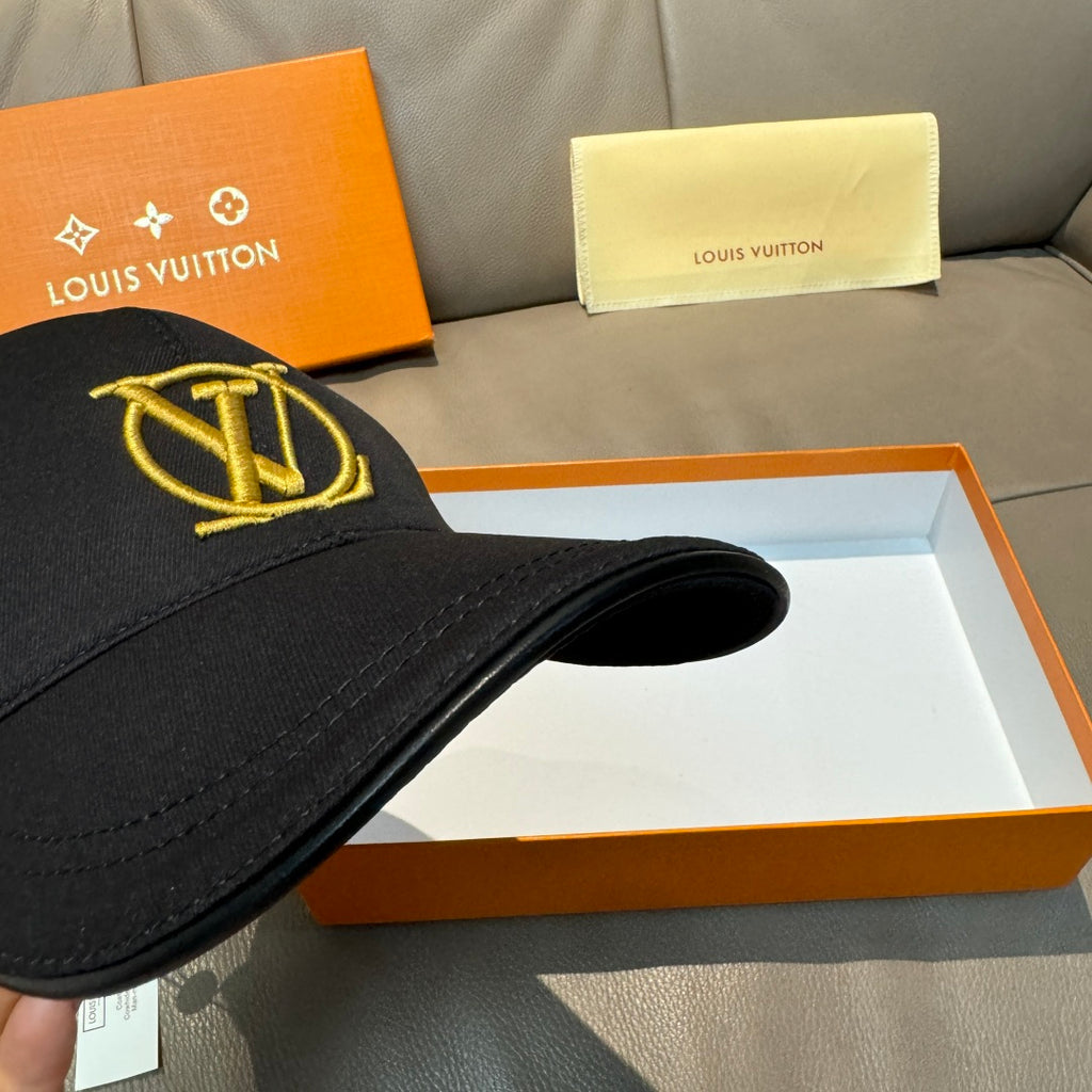 Louis Vuitton black baseball cap with gold LV logo, angled side view