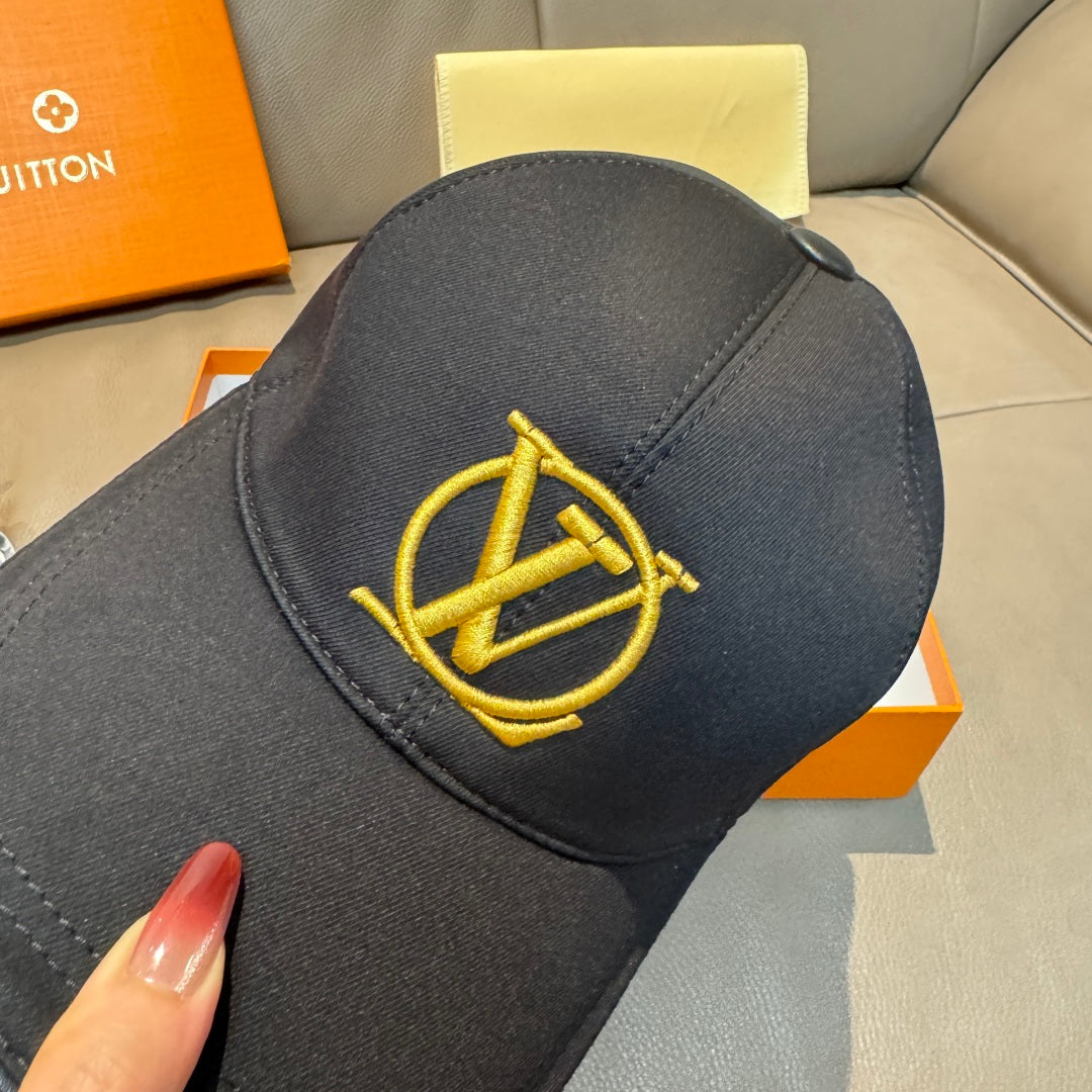 Louis Vuitton black cap close-up with gold LV logo embroidery on the front