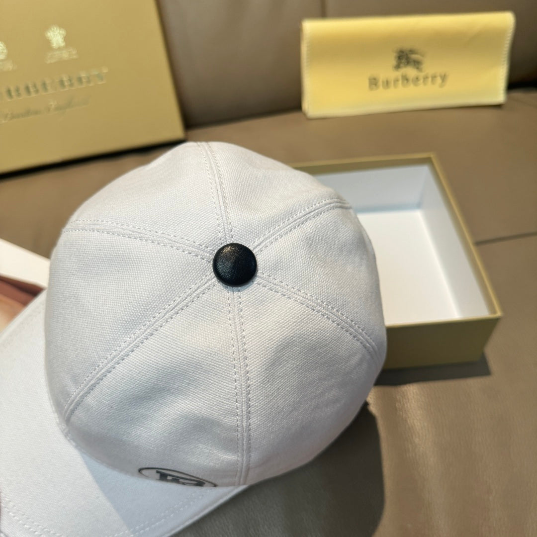 Light blue baseball cap top view with small dark button detail